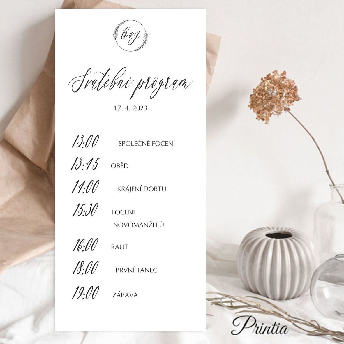 Wedding day schedule with a wreath with initials