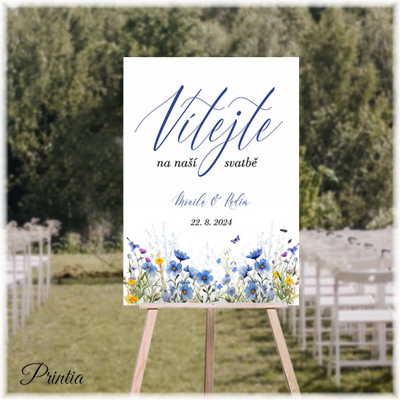Wedding welcome sign with a meadow of blue flowers
