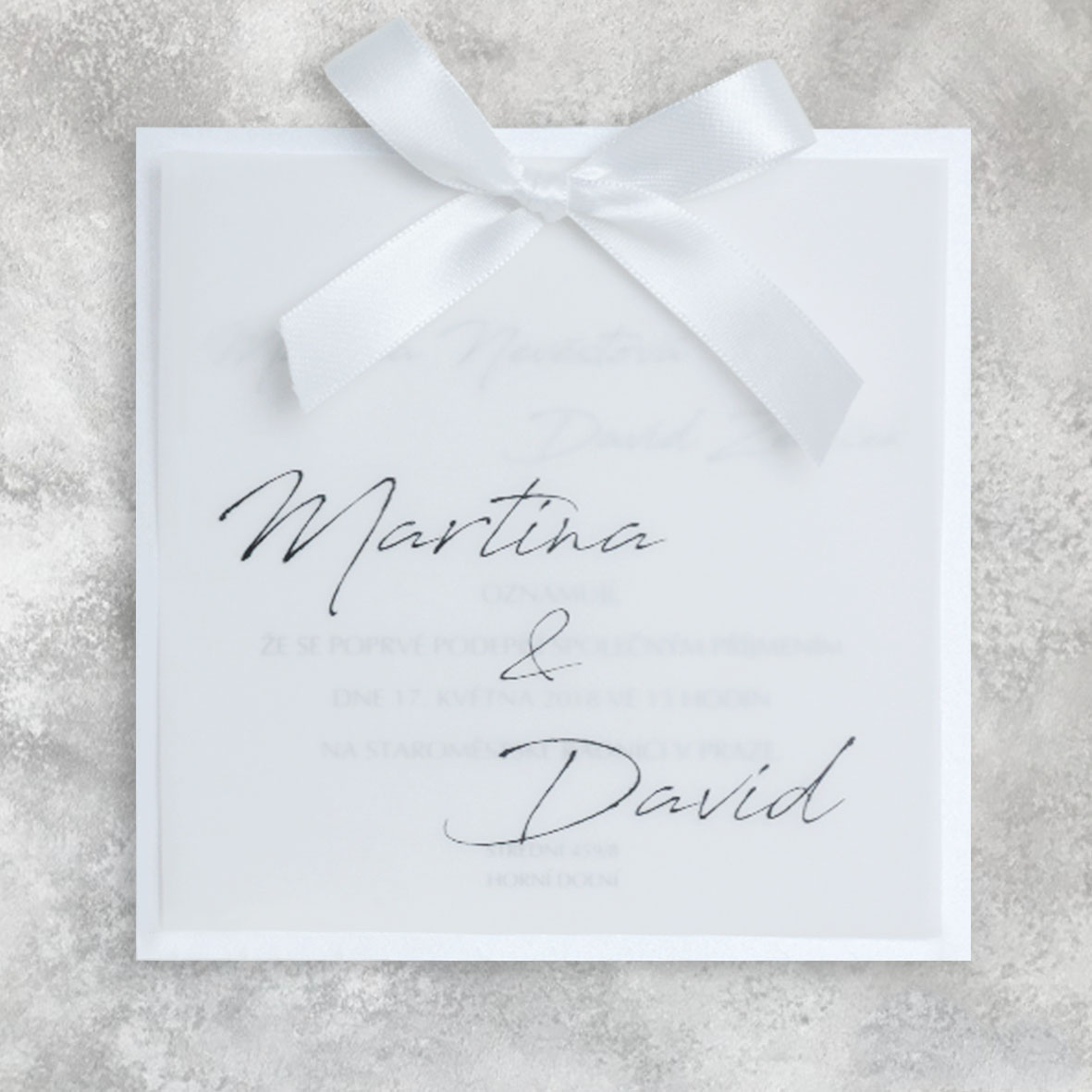 Transparent wedding invitation with a bow
