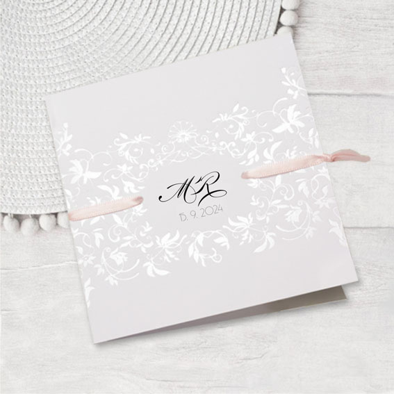 Opening elegant wedding invitation with a pearl embossed ornament