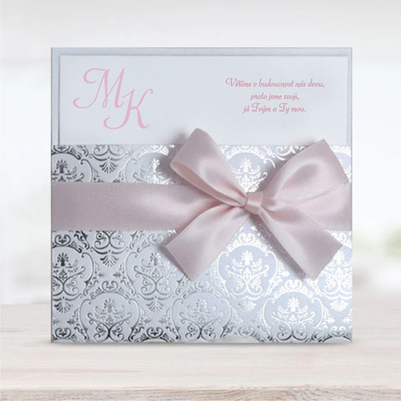 Luxury wedding invitation with pink ribbon and silver embossing