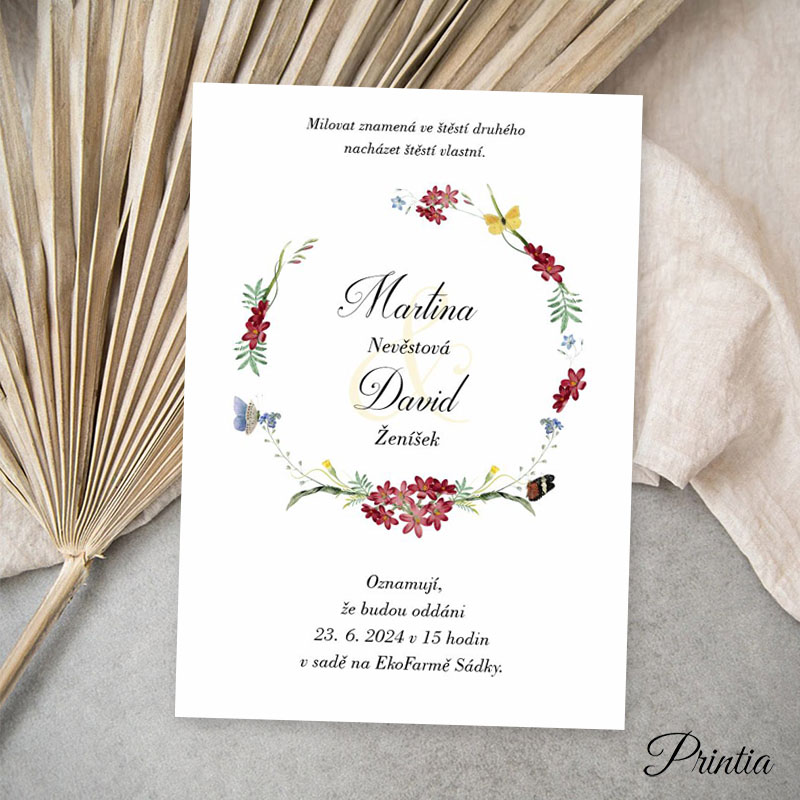 Wedding invitation with a wreath of meadow flowers