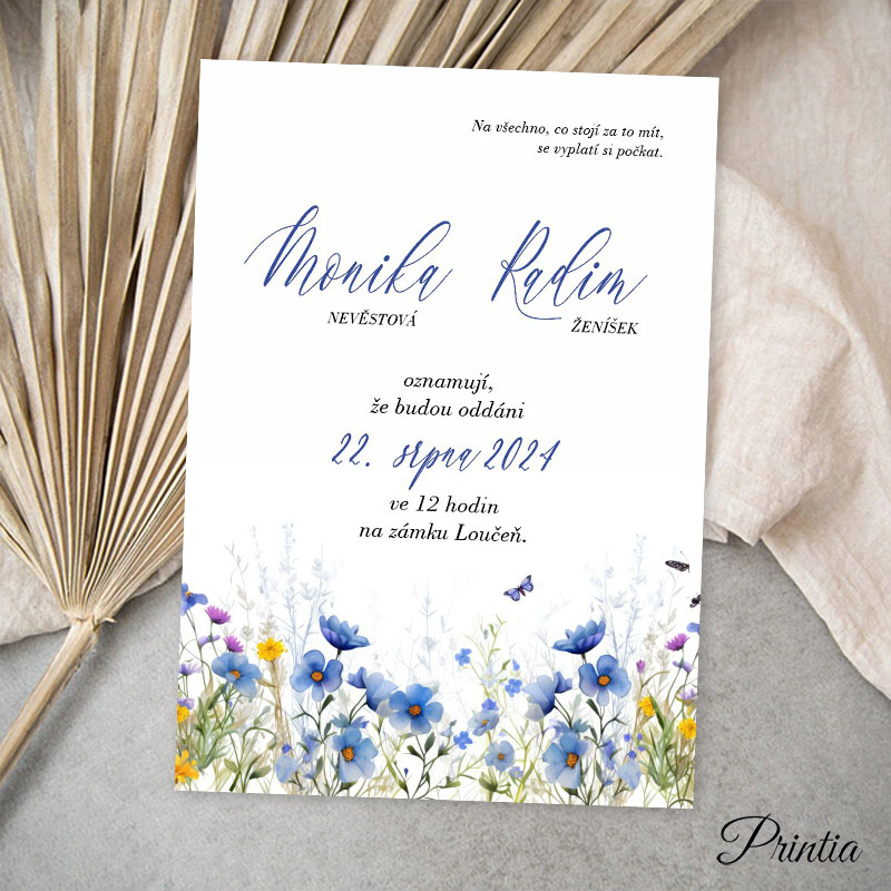 Wedding invitation with a meadow of blue flowers