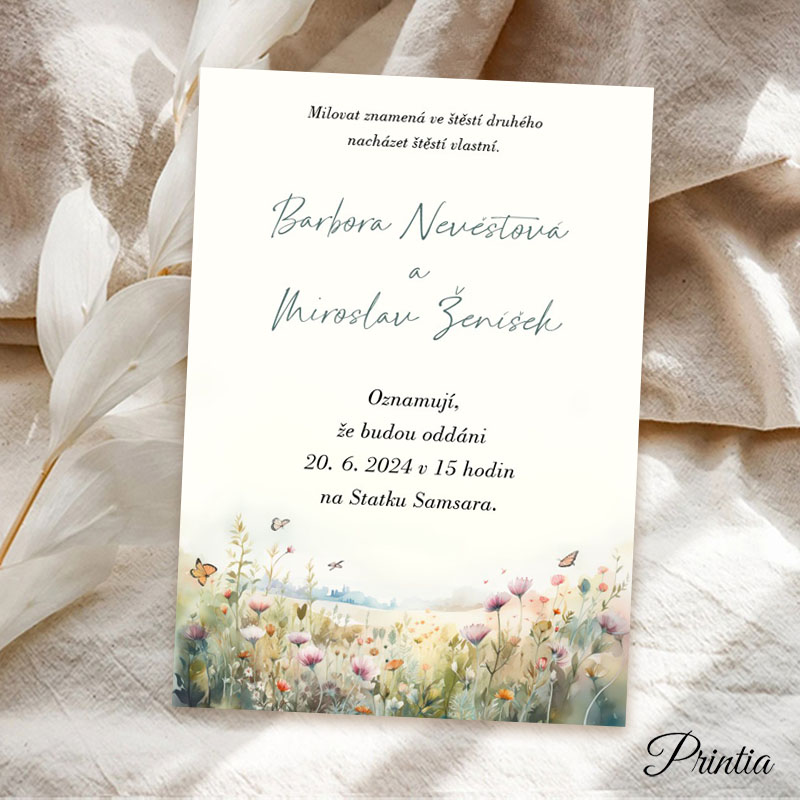 Wedding invitation on cream paper with a blooming meadow