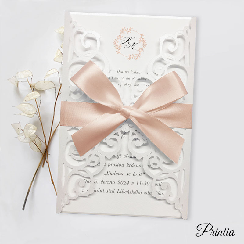 Wedding invitation with apricot ribbon and initials of the engaged couple