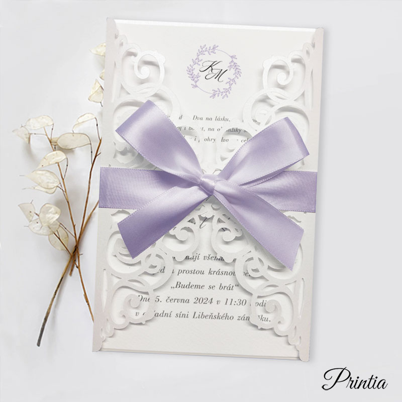 Wedding invitation with purple ribbon and initials of the engaged couple