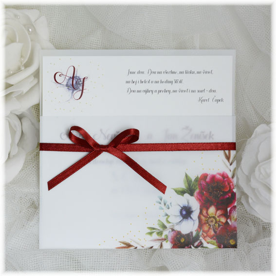 Wedding invitation made from transparent pocket with flowers and tied with a bow